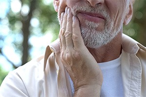 A man holding his mouth in pain