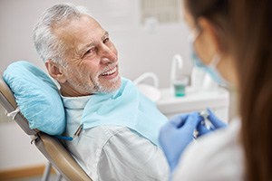 a patient speaking with his dentist about All-on-4 dental implants