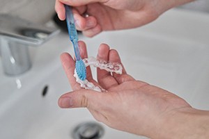 a person cleaning their aligners