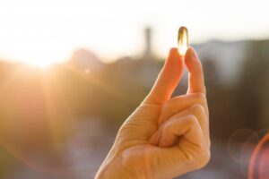 a person holding up a Vitamin D tablet