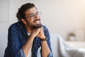 an adult with braces smiling